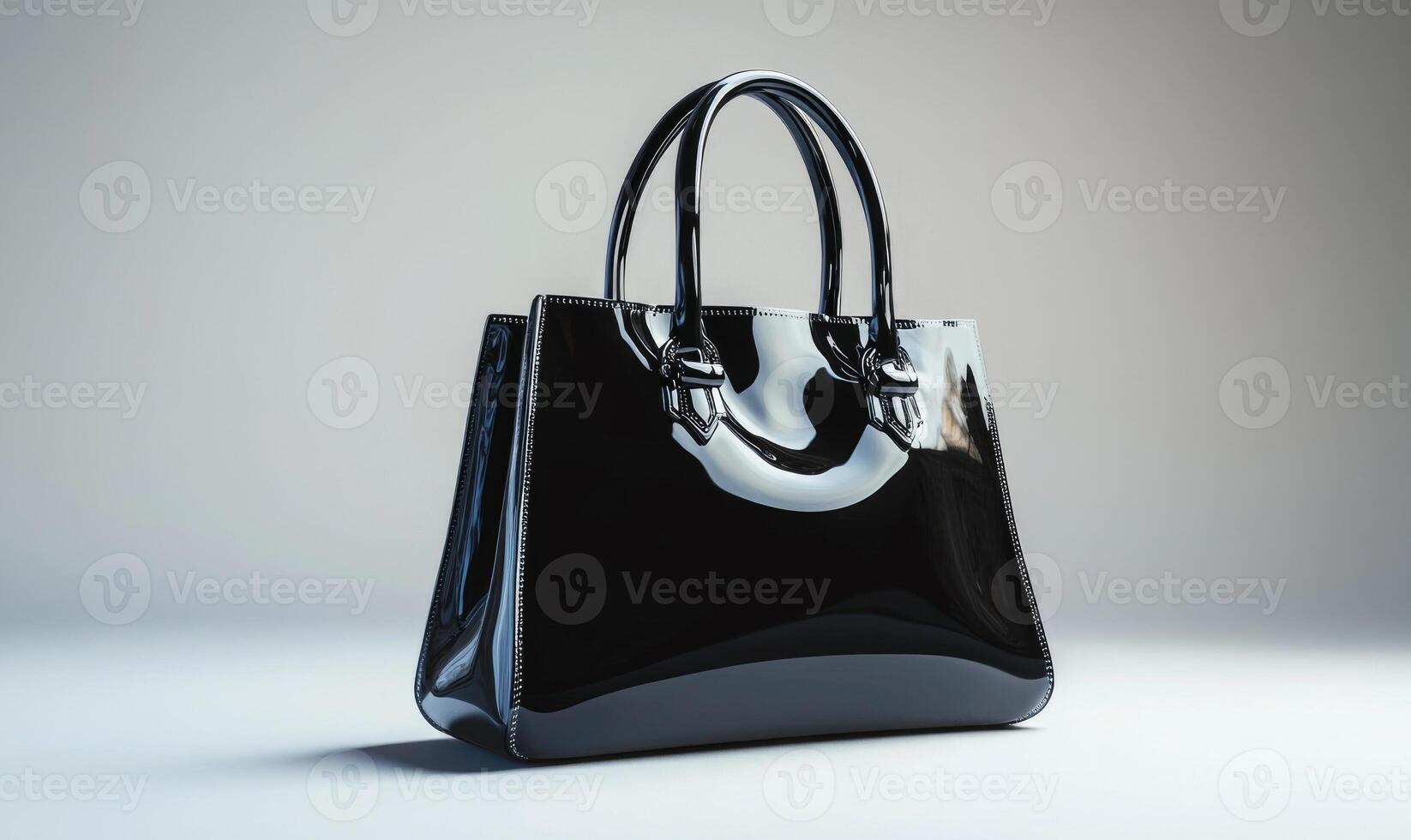 A black purse with a silver handle, gray background photo