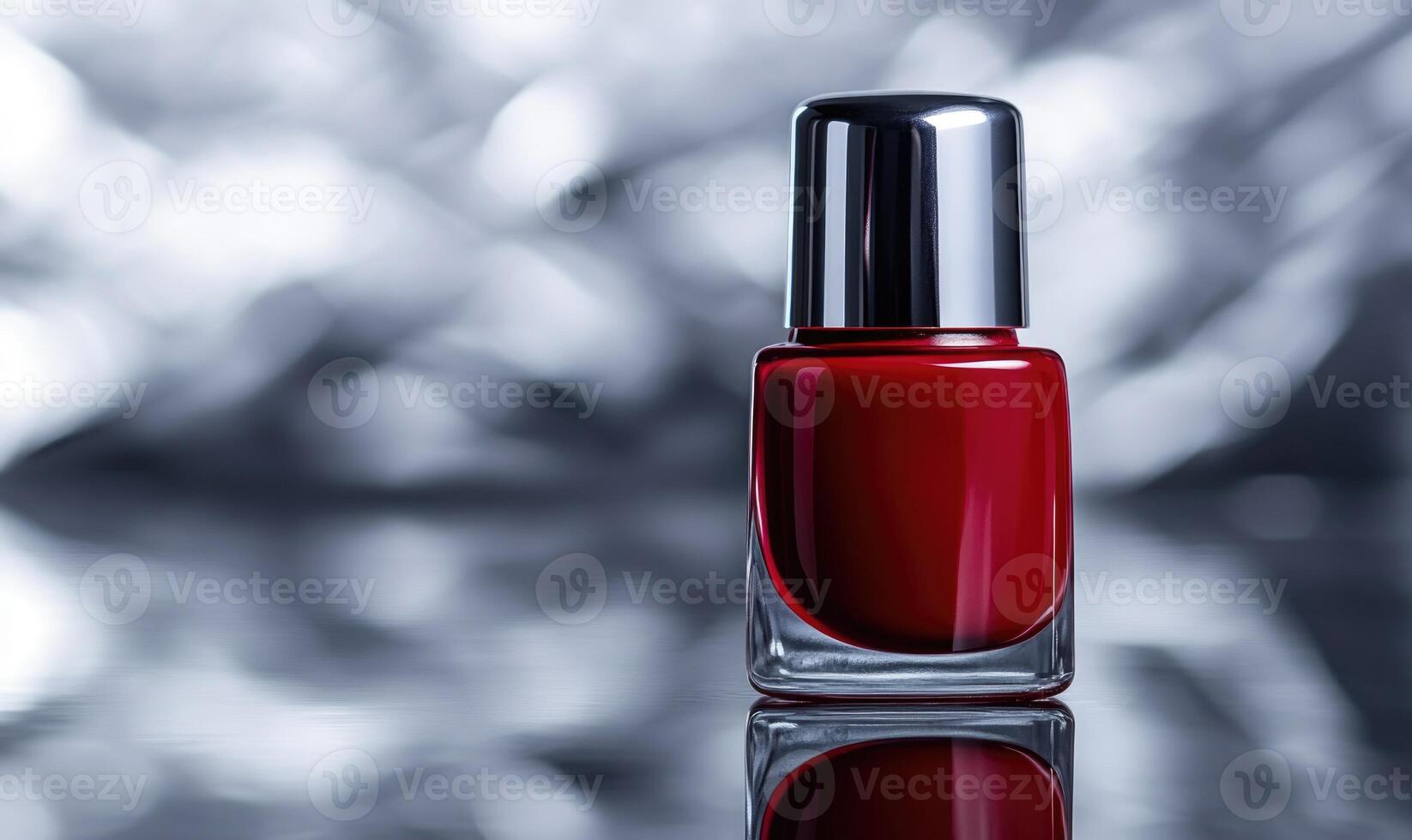 a red nail polish bottle on a shiny surface photo