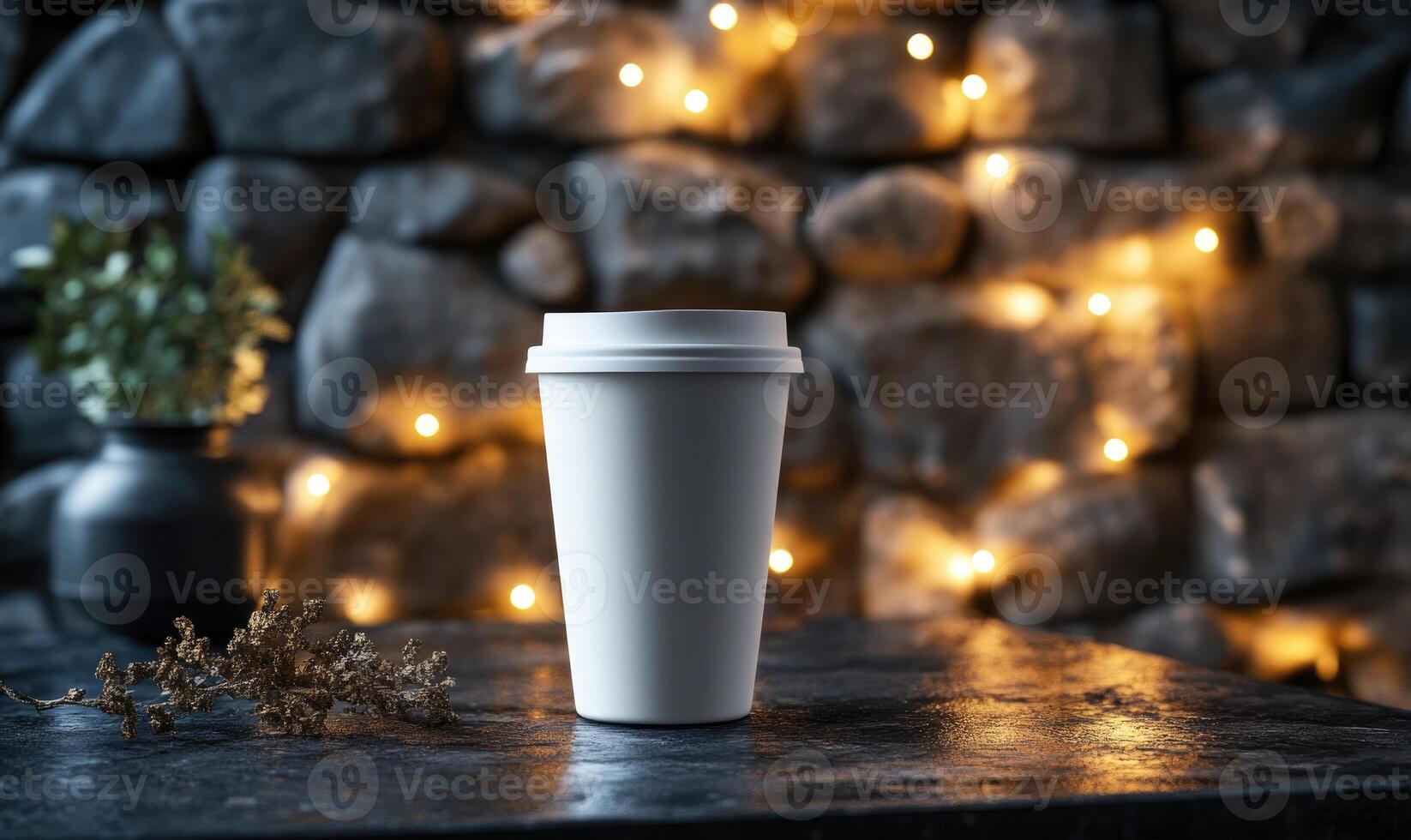 A white coffee cup sits on a table next to a plant photo