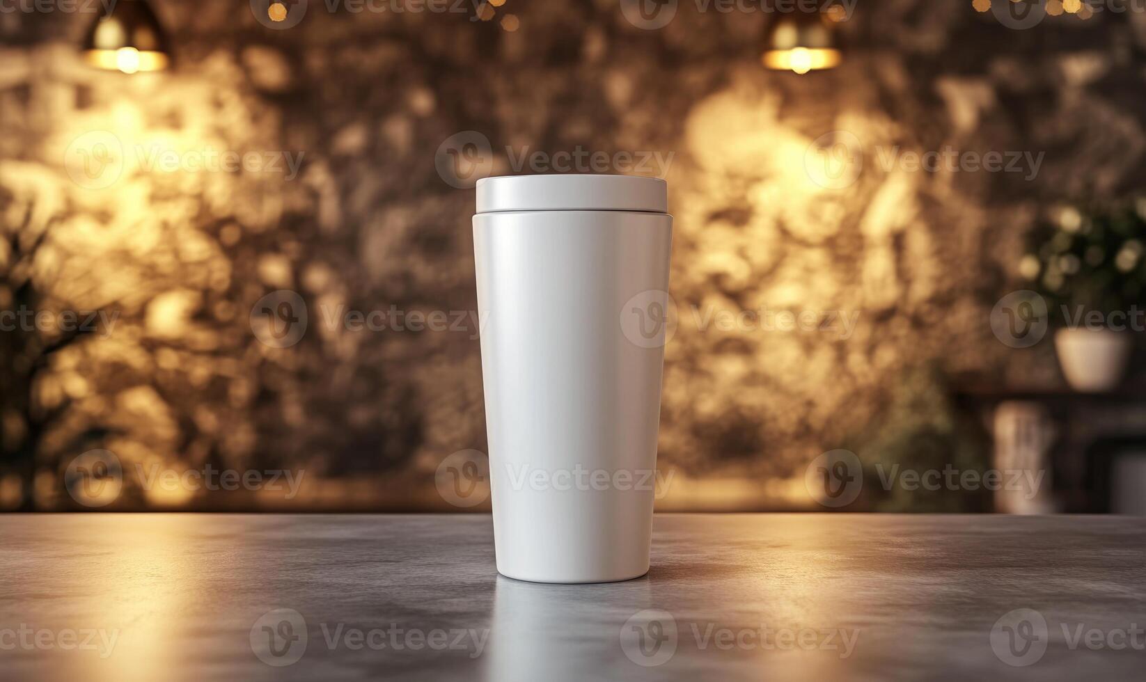 A white coffee cup sits on a table in front of a wall photo