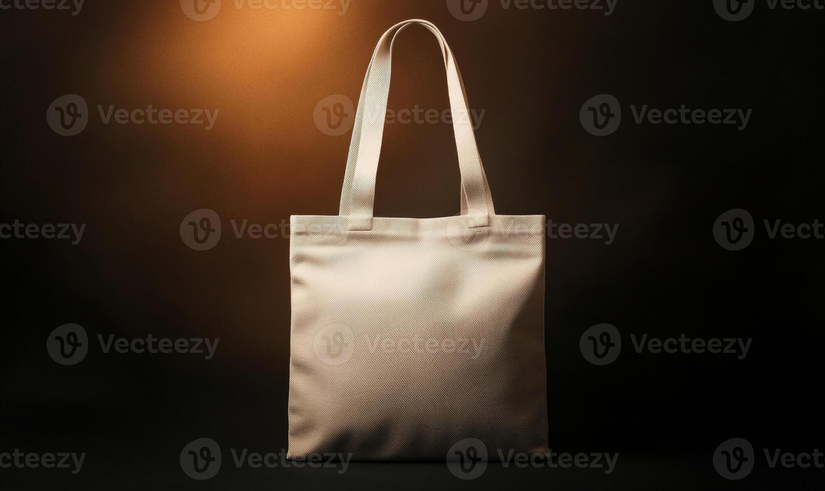 A tan tote bag with a zigzag pattern sits on a dark background photo