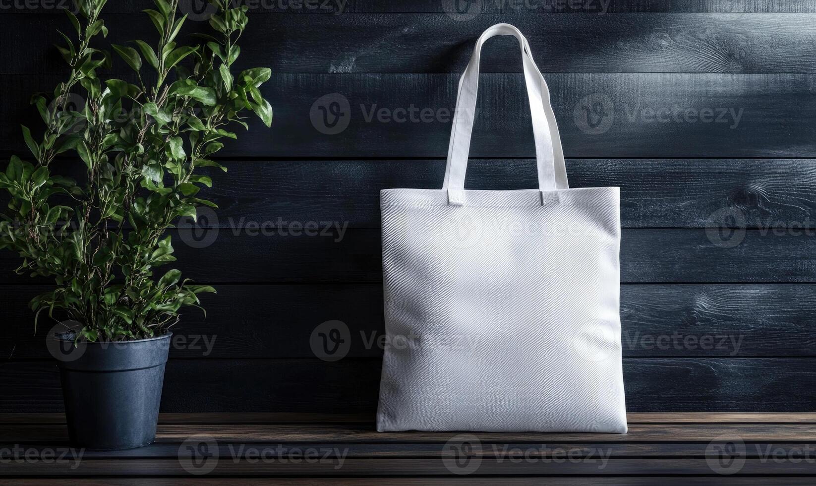 A white bag is on a wooden table next to a potted plant photo