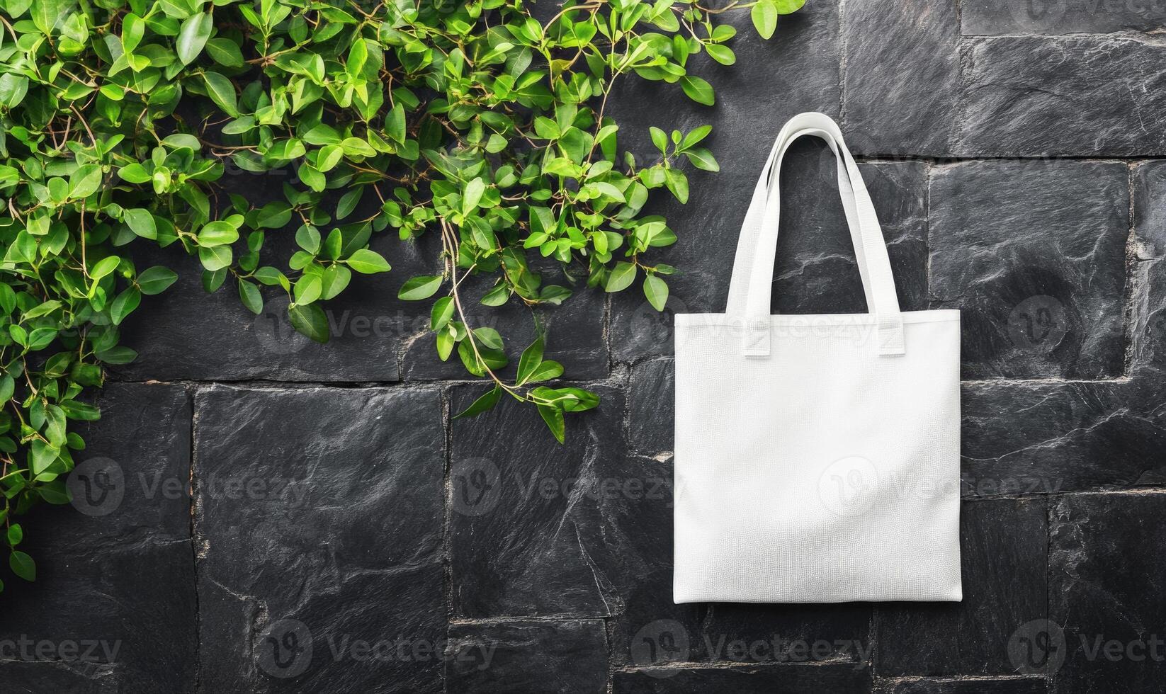 A white bag is hanging from a wall next to a green plant photo