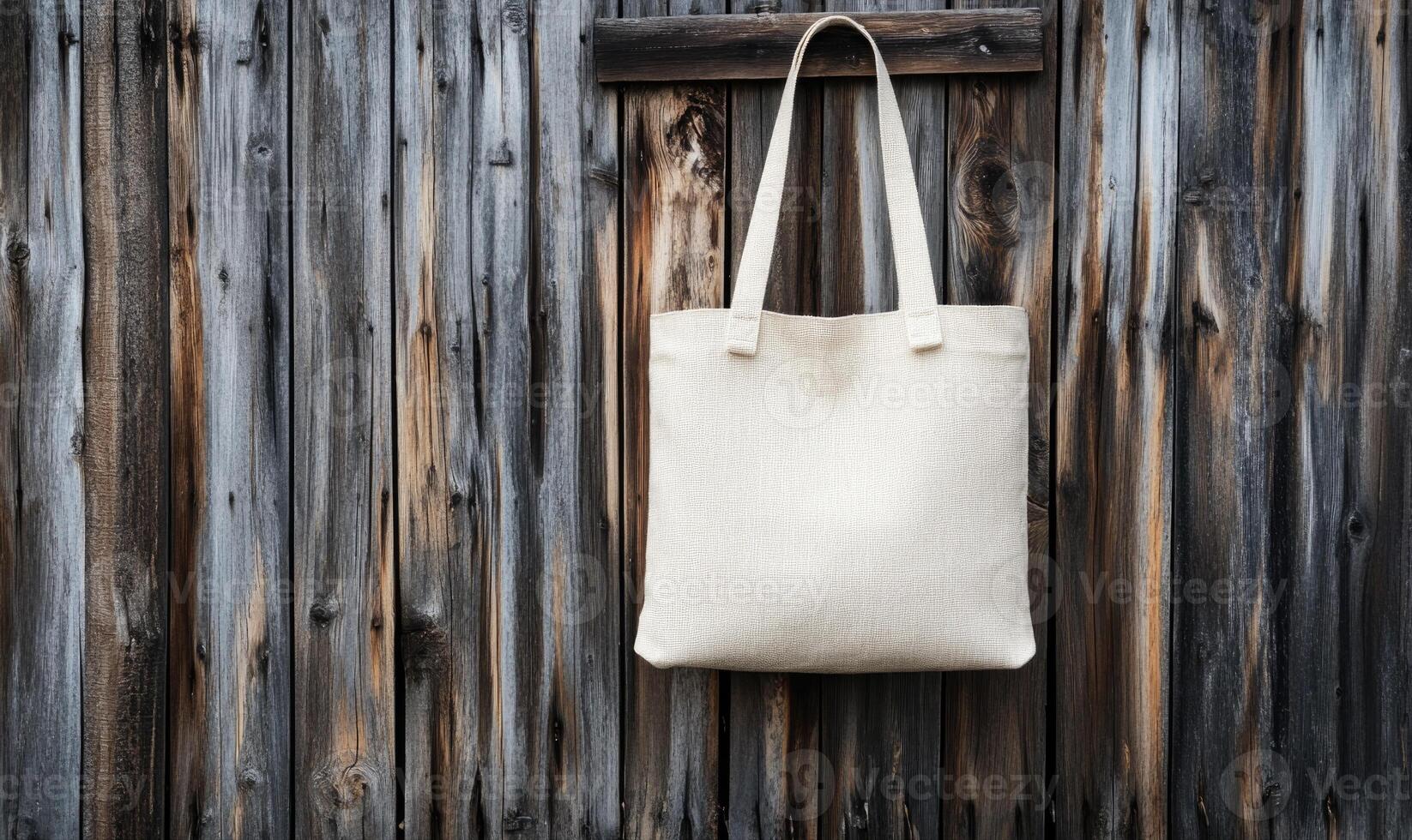 a white tote bag hanging on a wooden wall photo