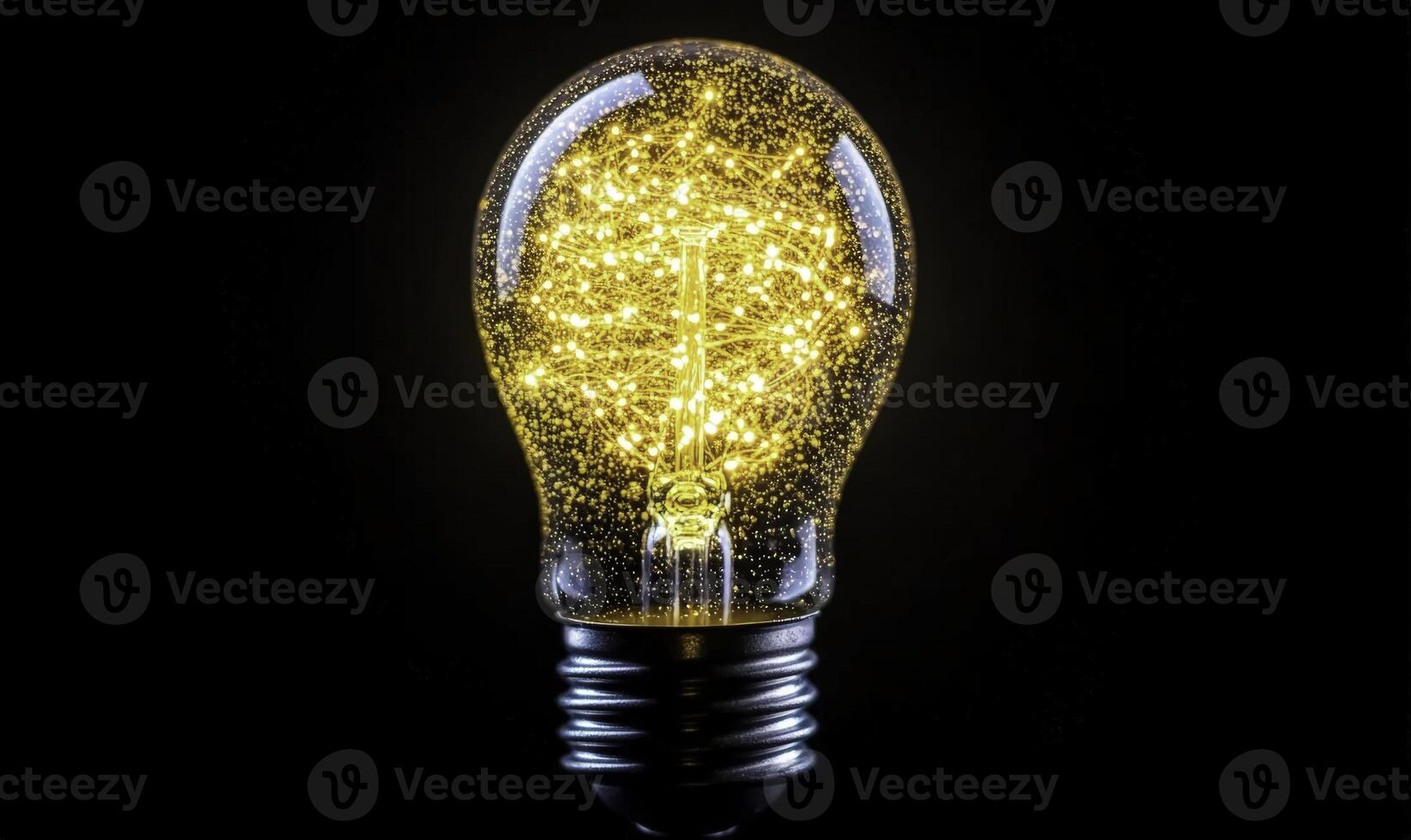Bright and illuminating light bulb with glowing golden particles and beautiful sparkles in a dark background creating a magical atmosphere and mood photo