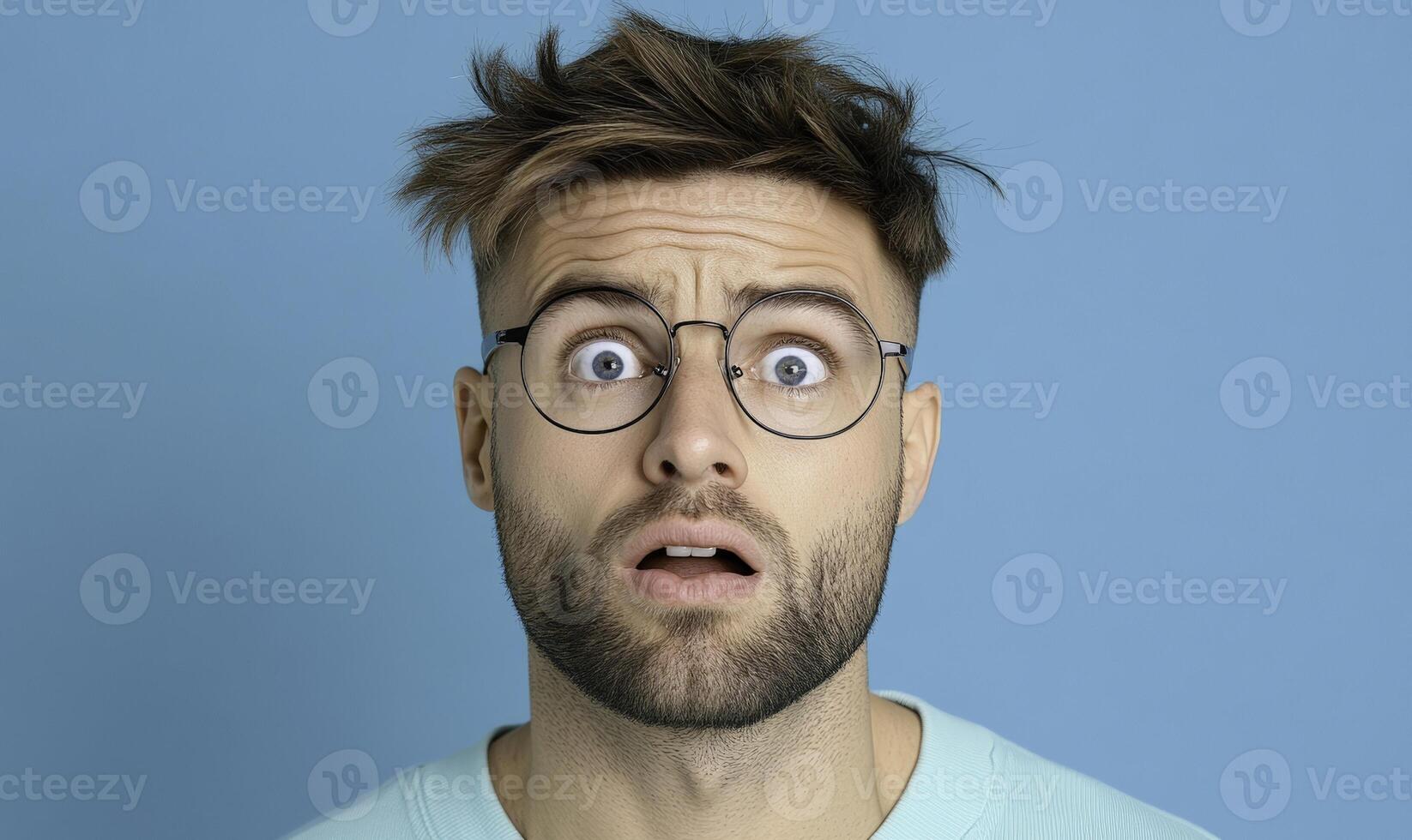 A man with glasses on his face looking surprised photo