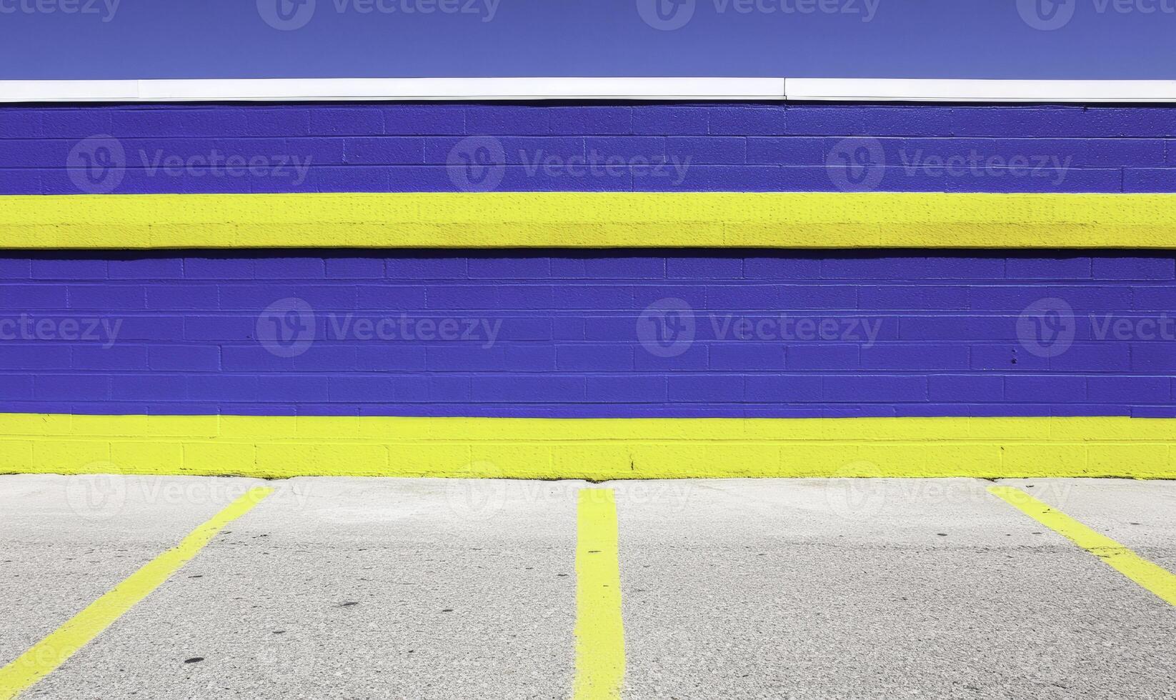 A blue and yellow striped wall with parking spaces photo