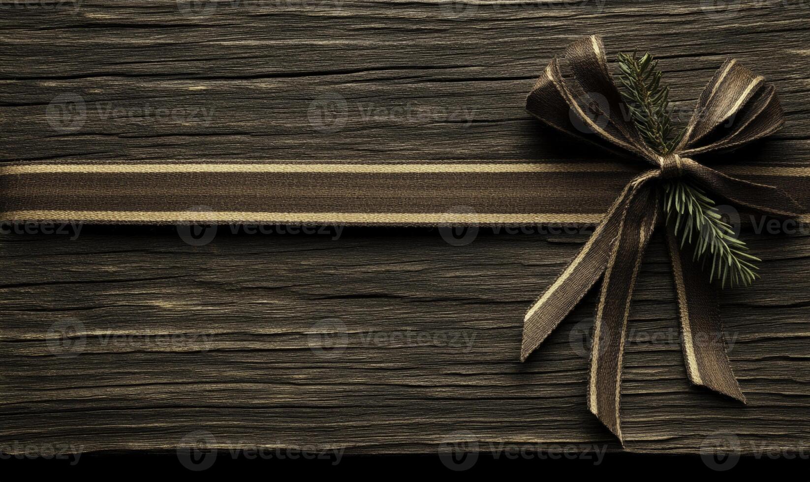 A brown ribbon tied to a wooden board with a spruce branch photo