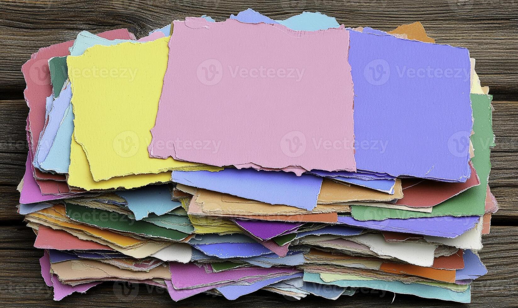 A pile of colorful paper on a wooden table photo