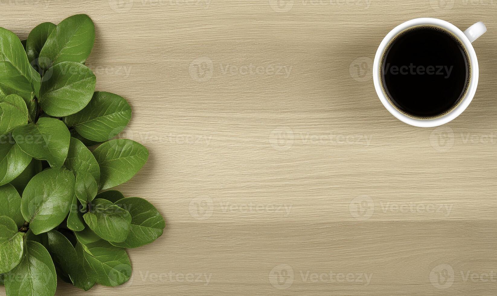 Coffee and green leaves on wooden table photo