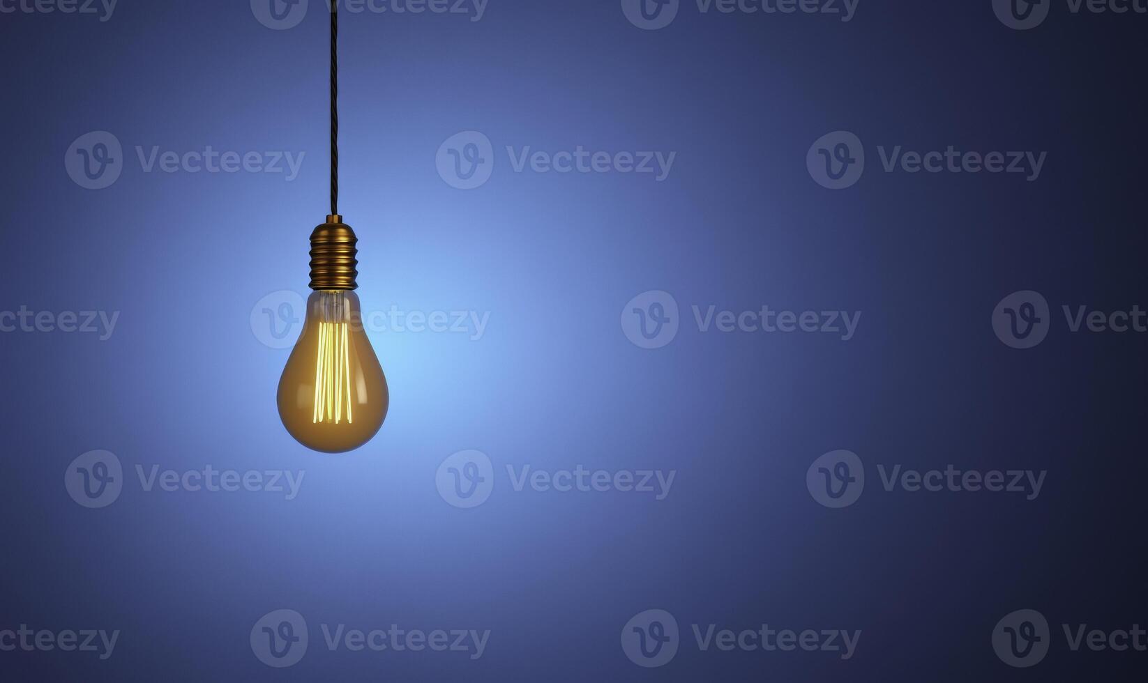 A light bulb hanging from a wire on a blue background photo