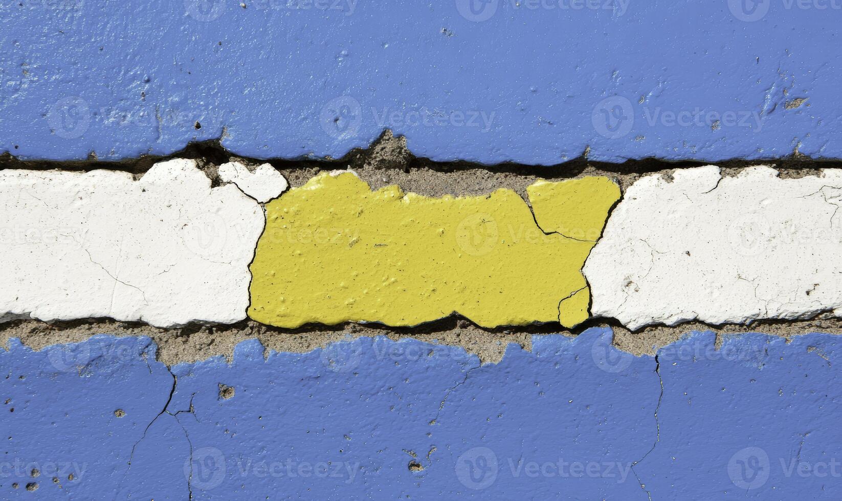 A yellow and blue painted wall with a crack in it photo