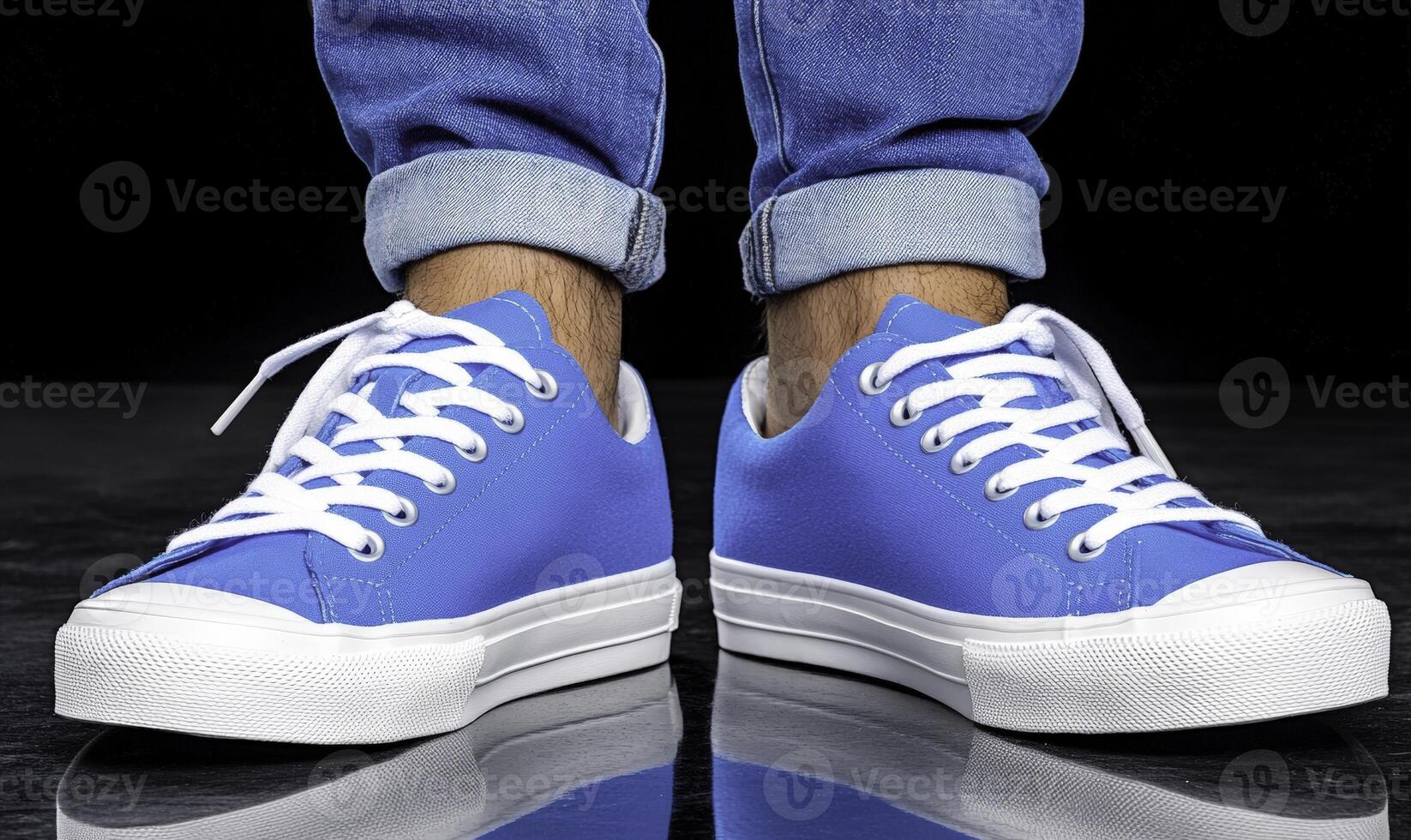 Blue sneakers with white laces on a black background photo