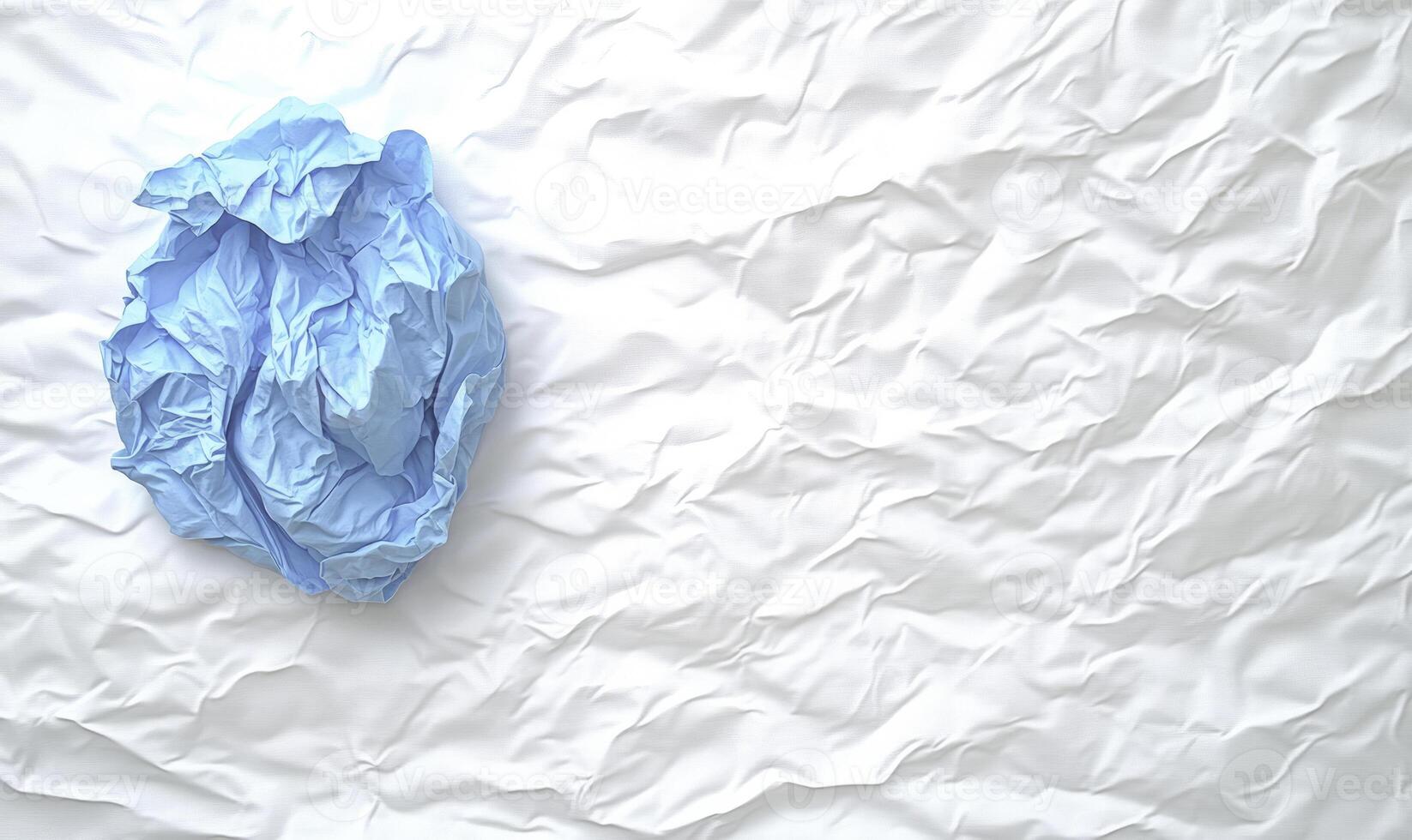 A blue cloth is on top of a white sheet photo