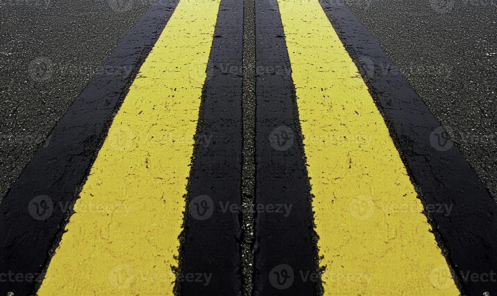 A yellow and black line on the road photo