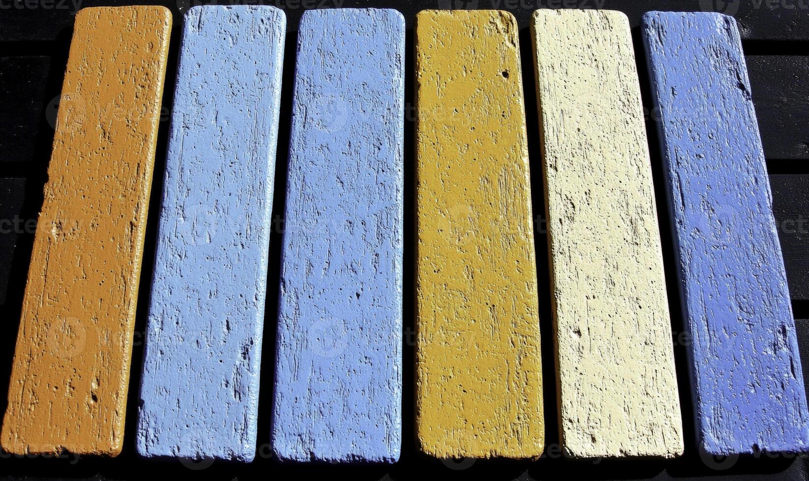 A row of painted wooden boards with different colors photo