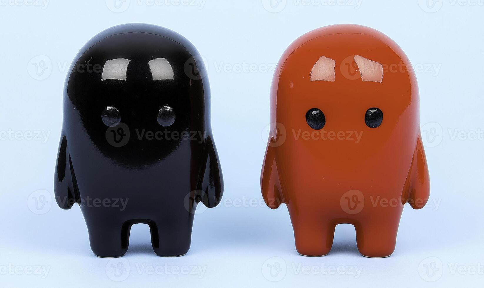 Two black and orange figurines standing next to each other photo