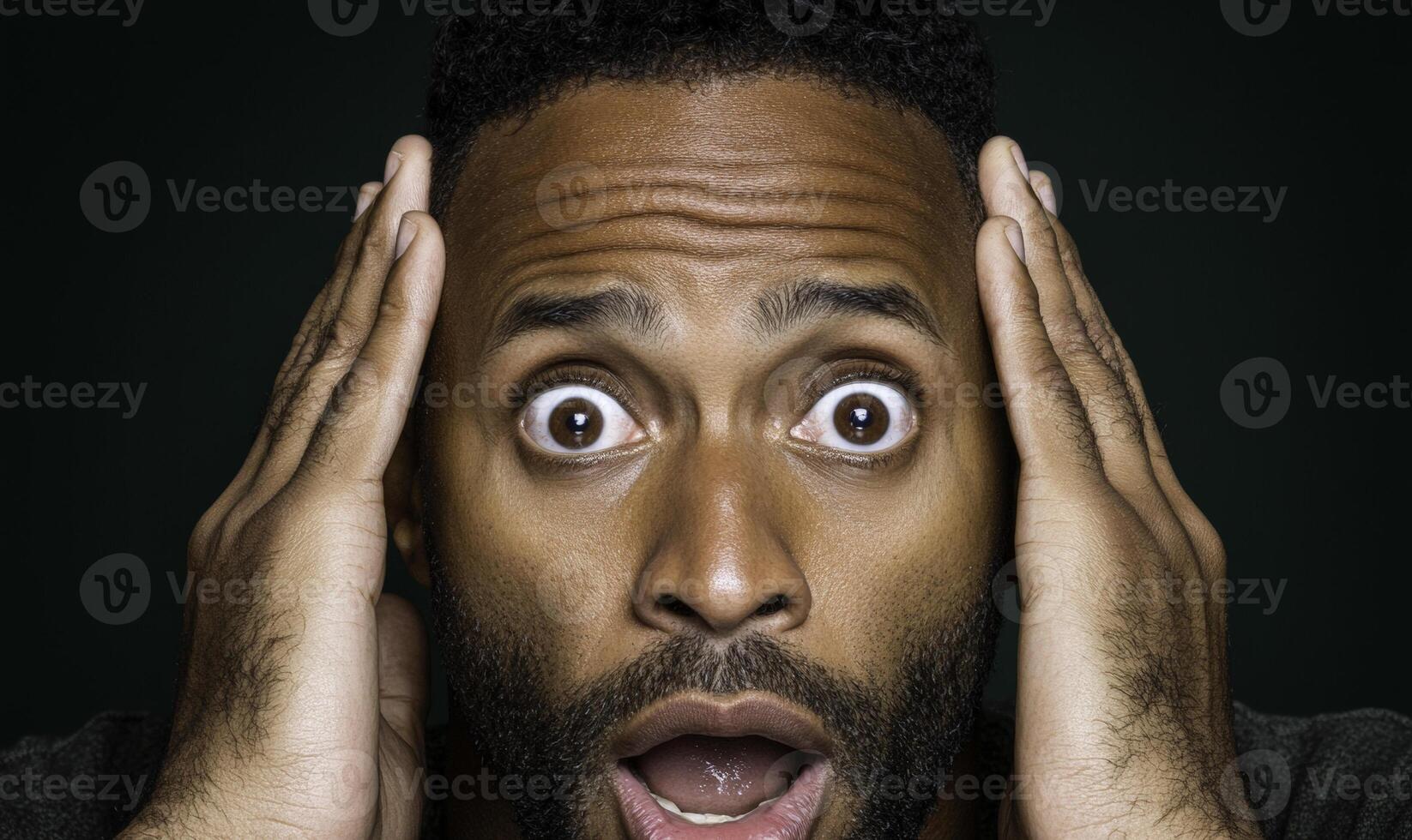 A man with his hands on his head and a surprised look photo