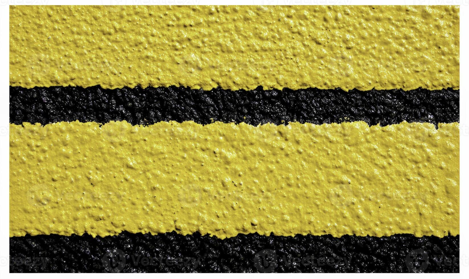 A yellow and black striped wall with black lines photo