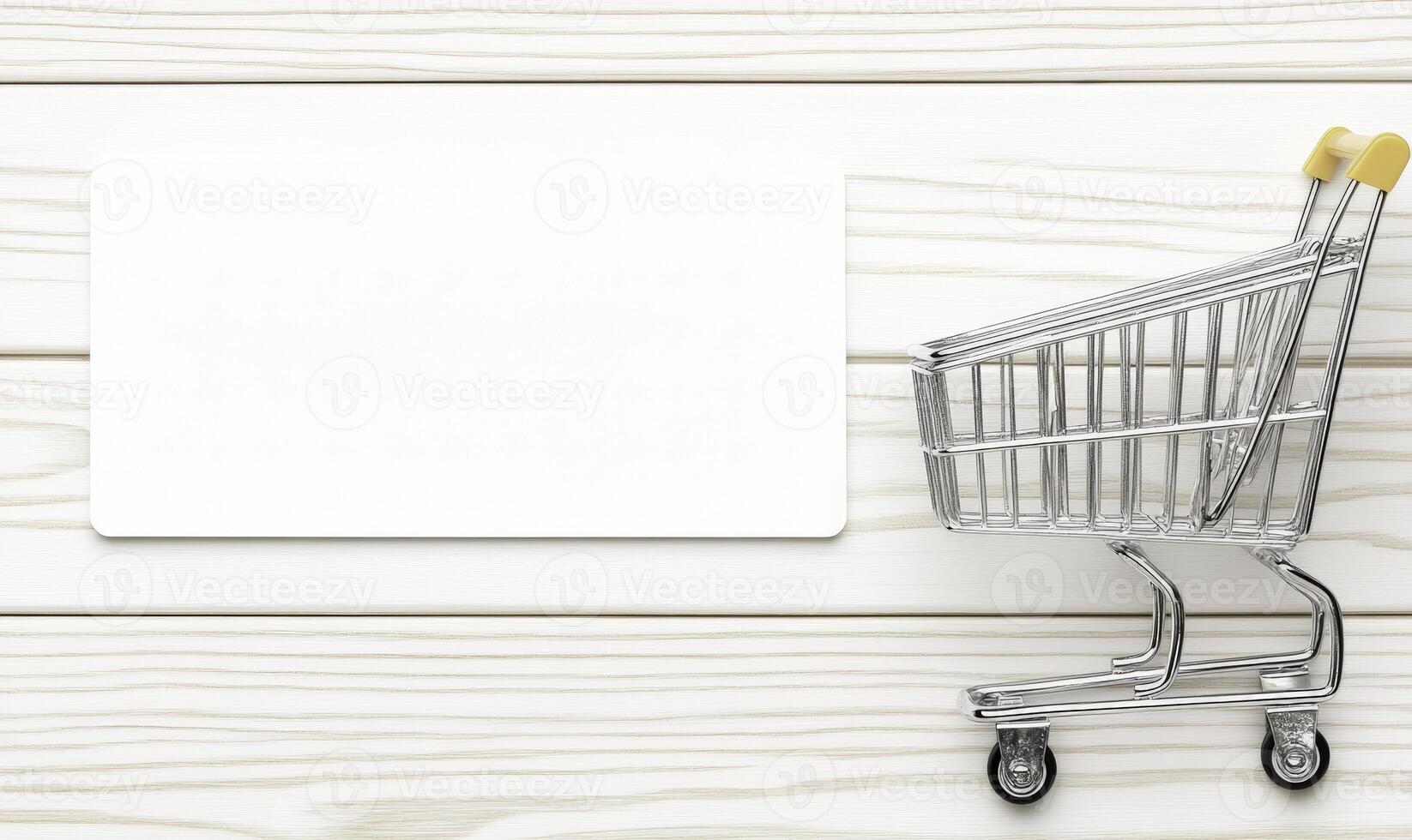 A shopping cart with a blank card on a wooden table photo