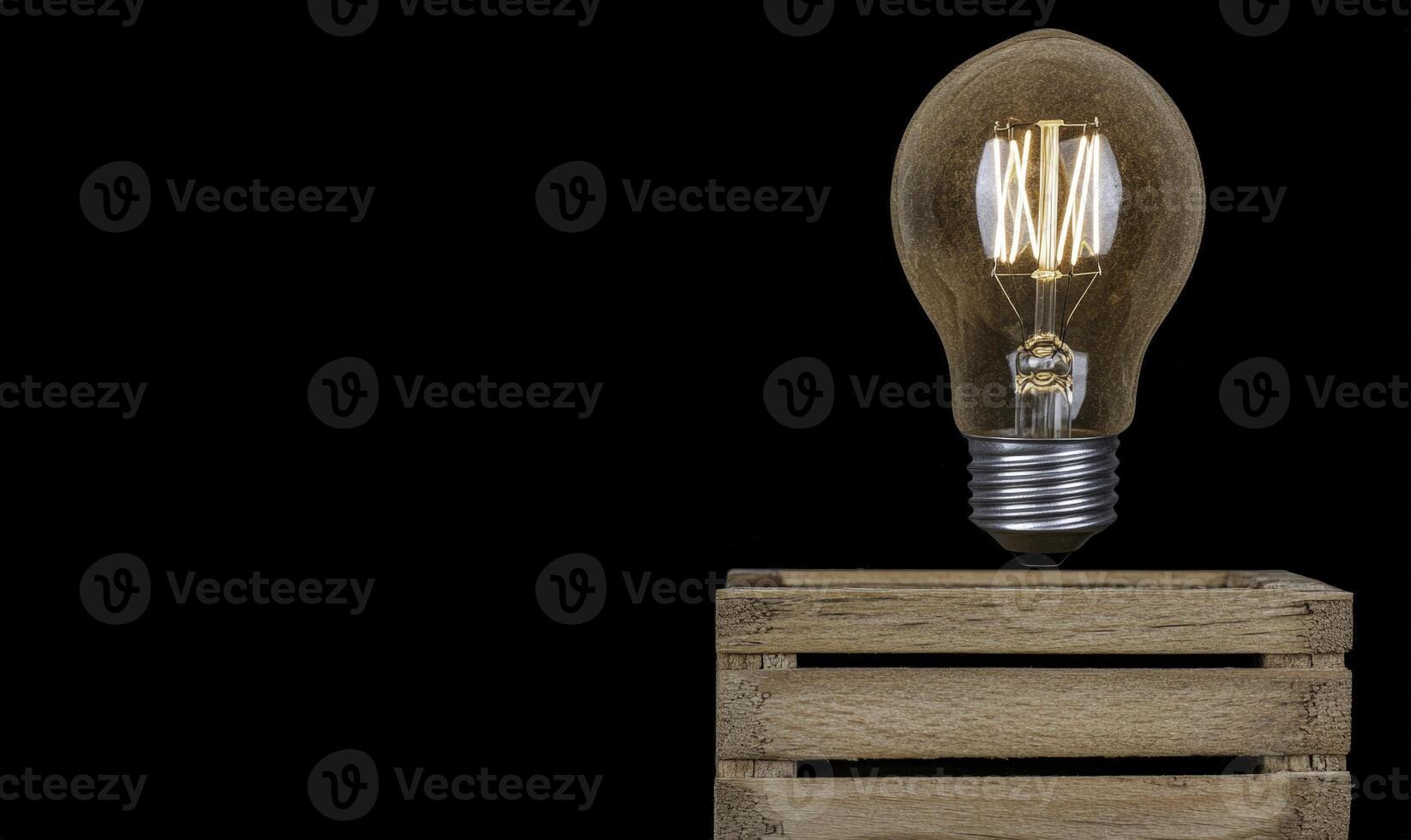 A light bulb is sitting on top of a wooden crate photo