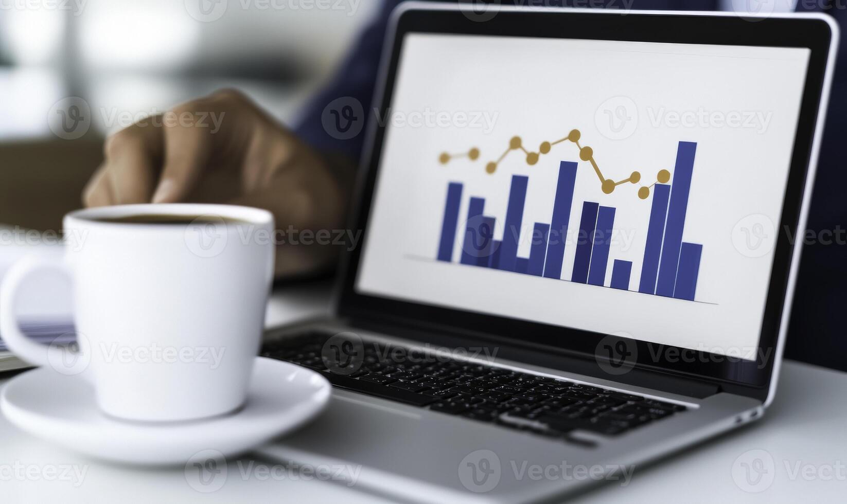 Businessman using laptop to view graphs on screen photo