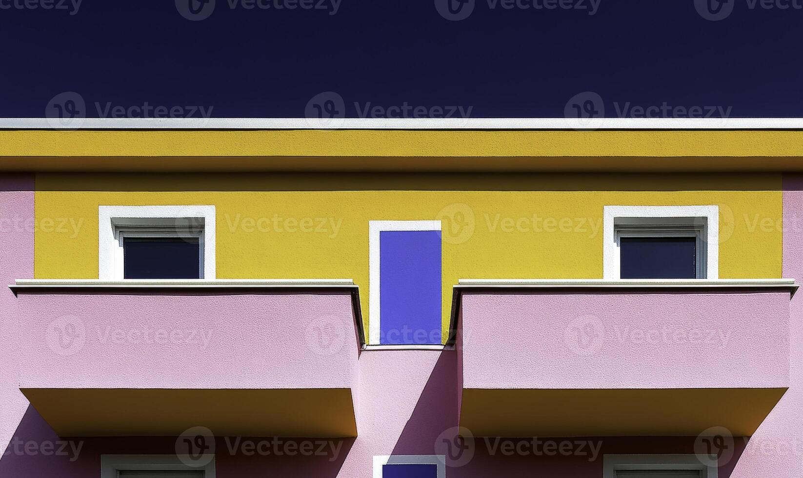 A colorful building with two balconies and a blue sky photo