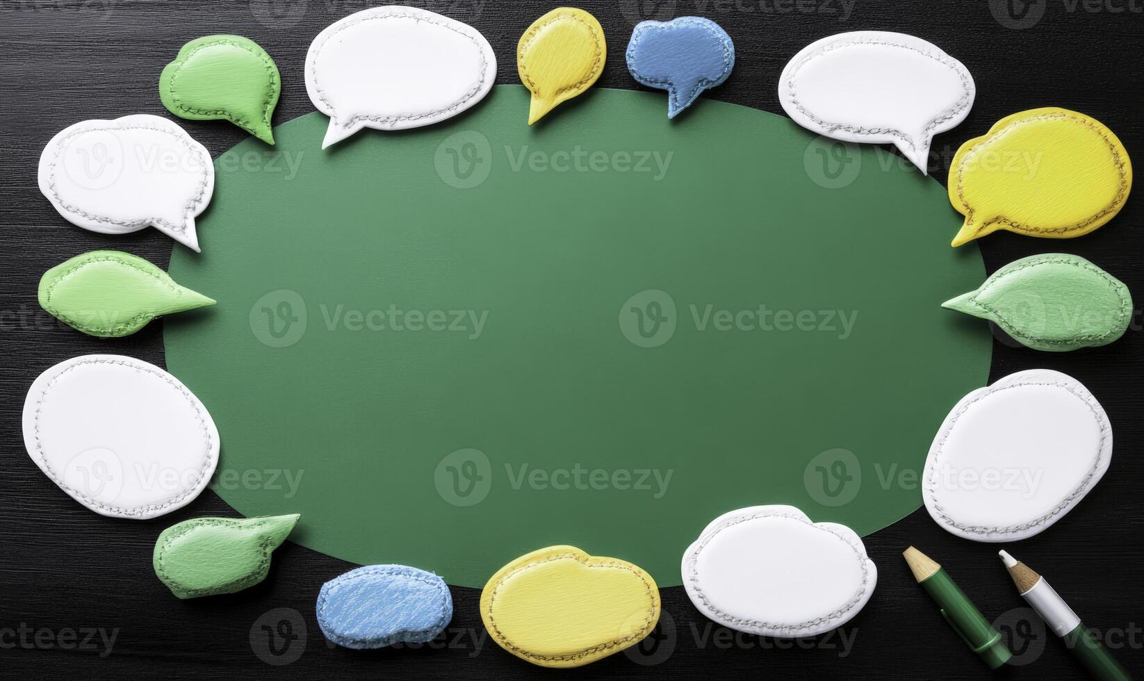 Colorful Speech Bubbles on Chalkboard Surface for Creative Communication Concepts and Ideas with Green Background and Stationery Items Nearby photo