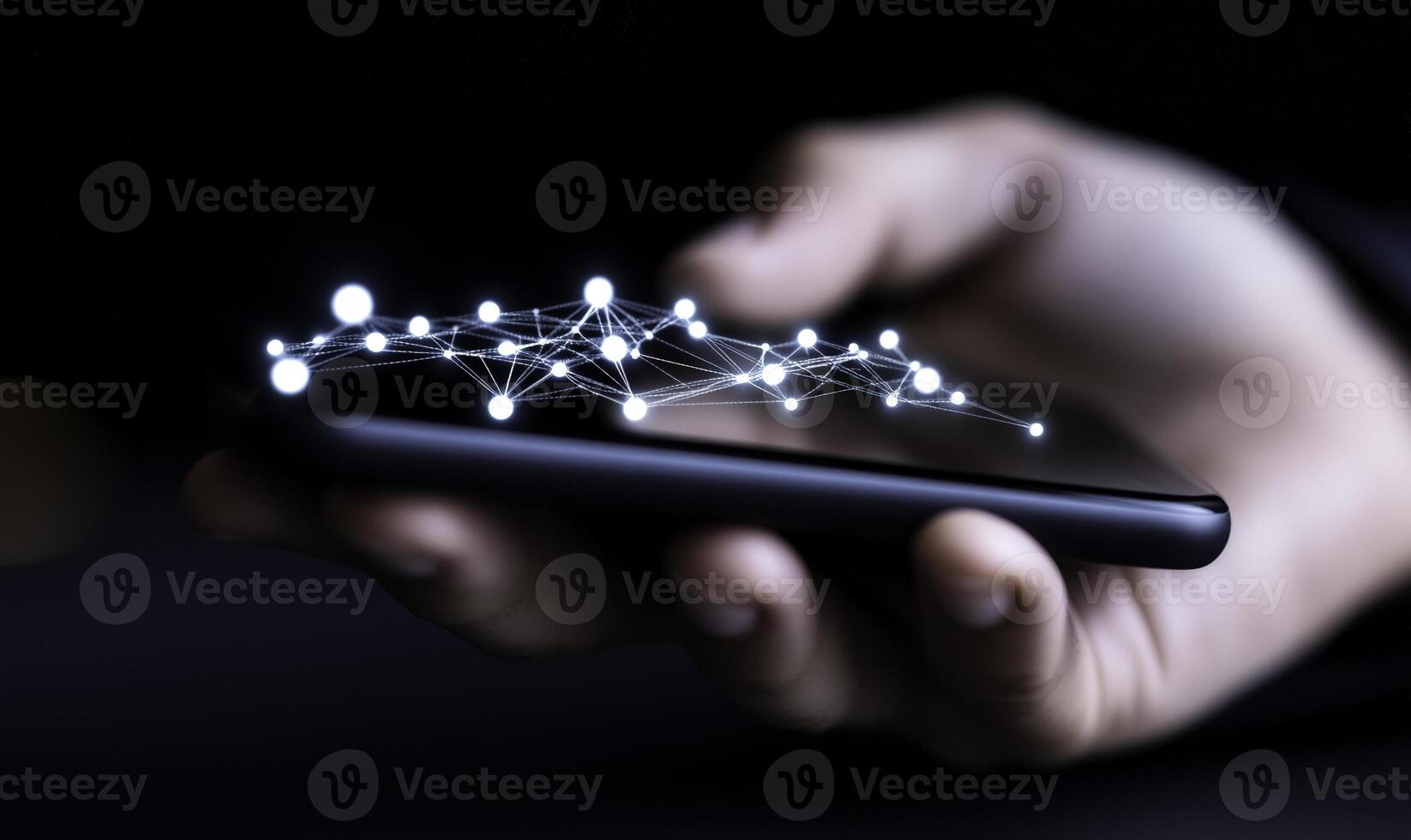 Hand holding smartphone with glowing network connections symbolizing digital communication and modern technology in a dark environment photo