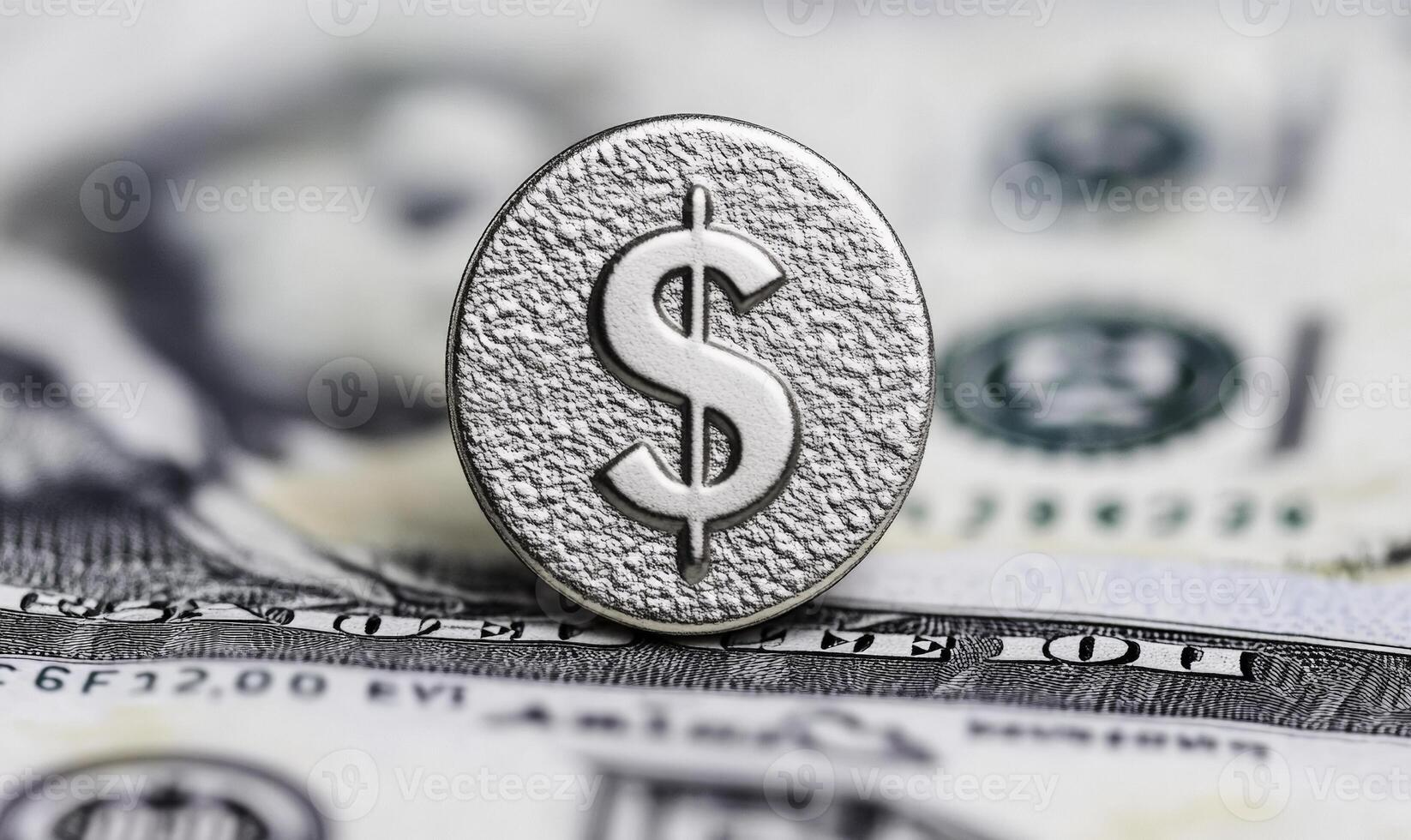 Silver dollar symbol on textured surface overlaid on US banknotes with blurred background highlighting concepts of finance, wealth, and currency transactions photo