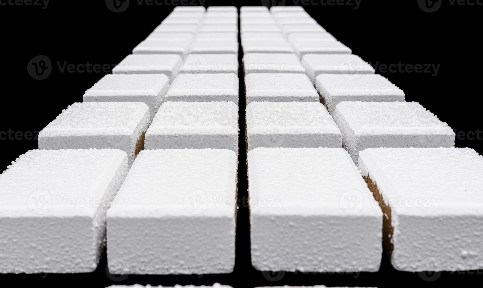 White sugar cubes arranged in a perfect geometric pattern on a black background showcasing detail, texture, and composition for culinary and food visuals photo