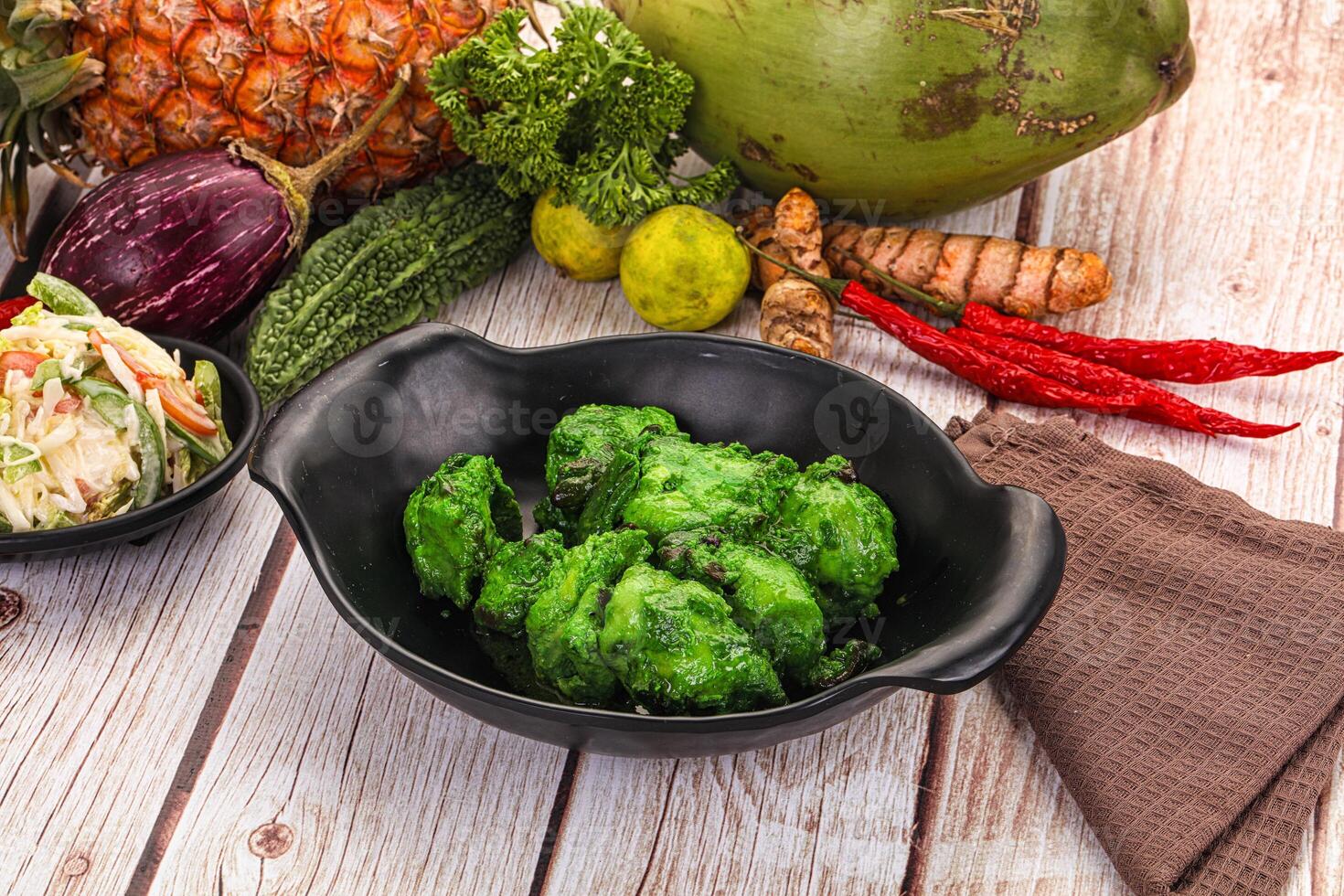 A table with a bowl of vegetables and a bowl of fruit photo