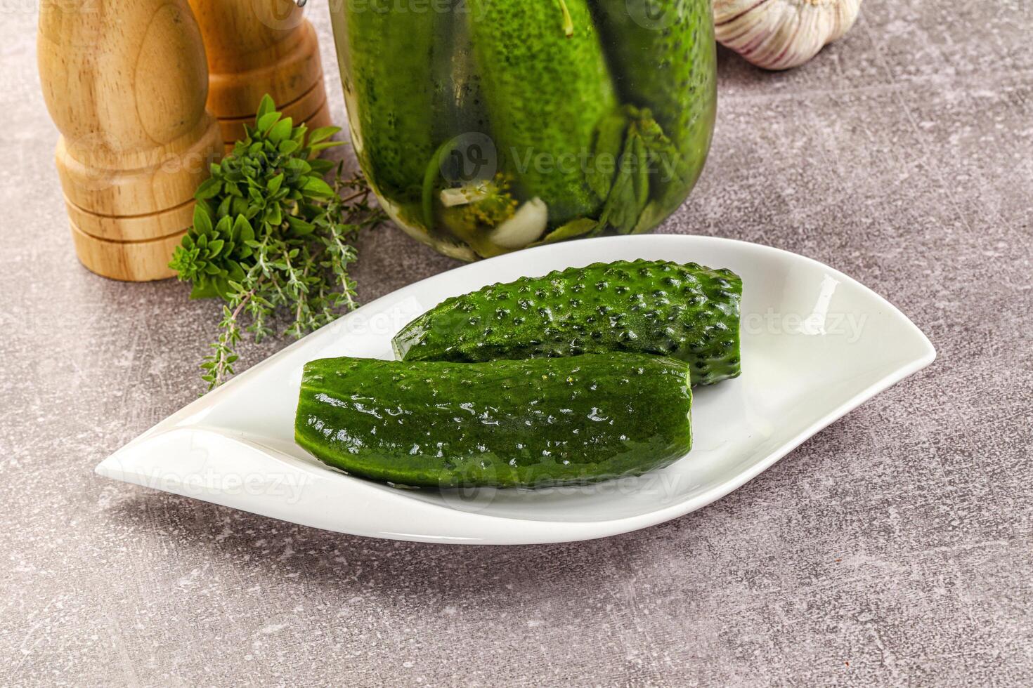 A white plate with cucumbers and garlic on it photo