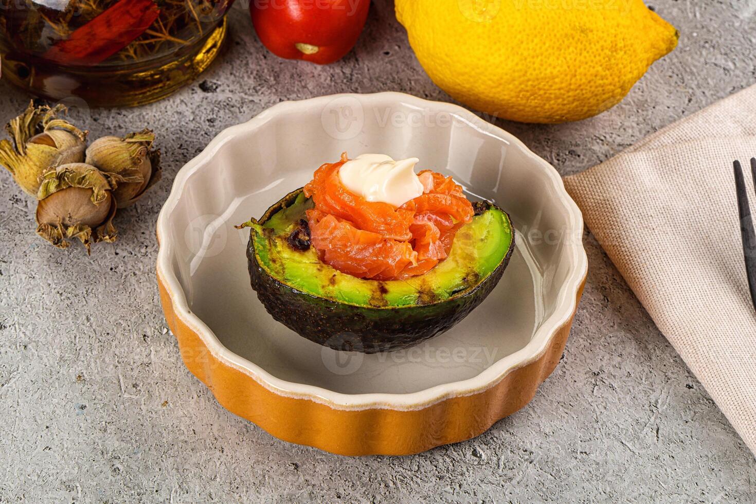 A bowl of food with a salmon and avocado on it photo