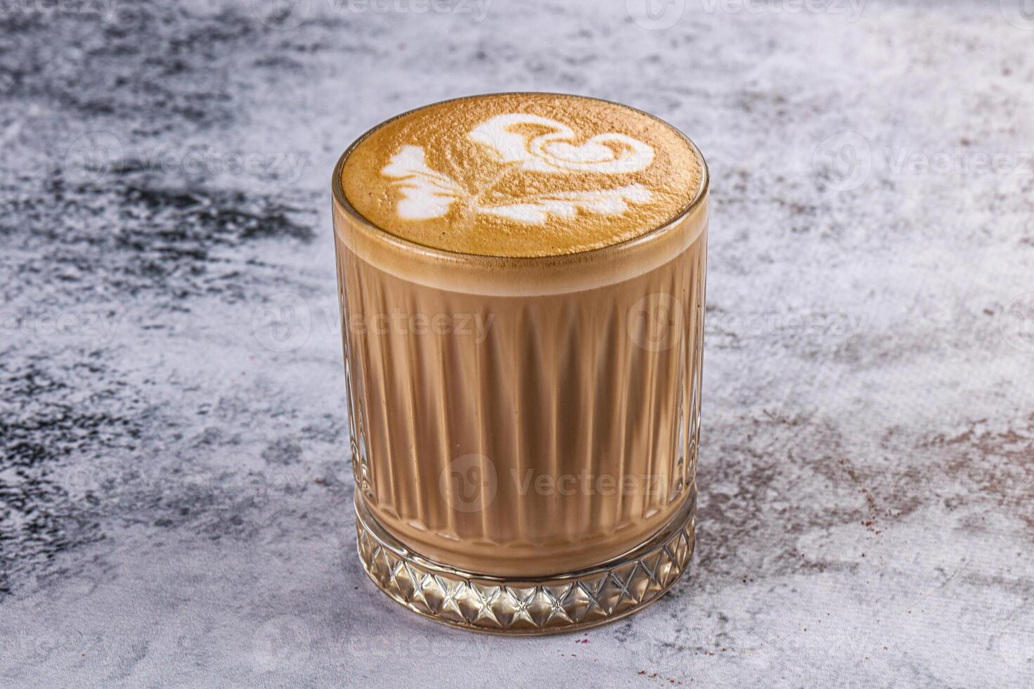 A coffee with a rose pattern in the middle photo