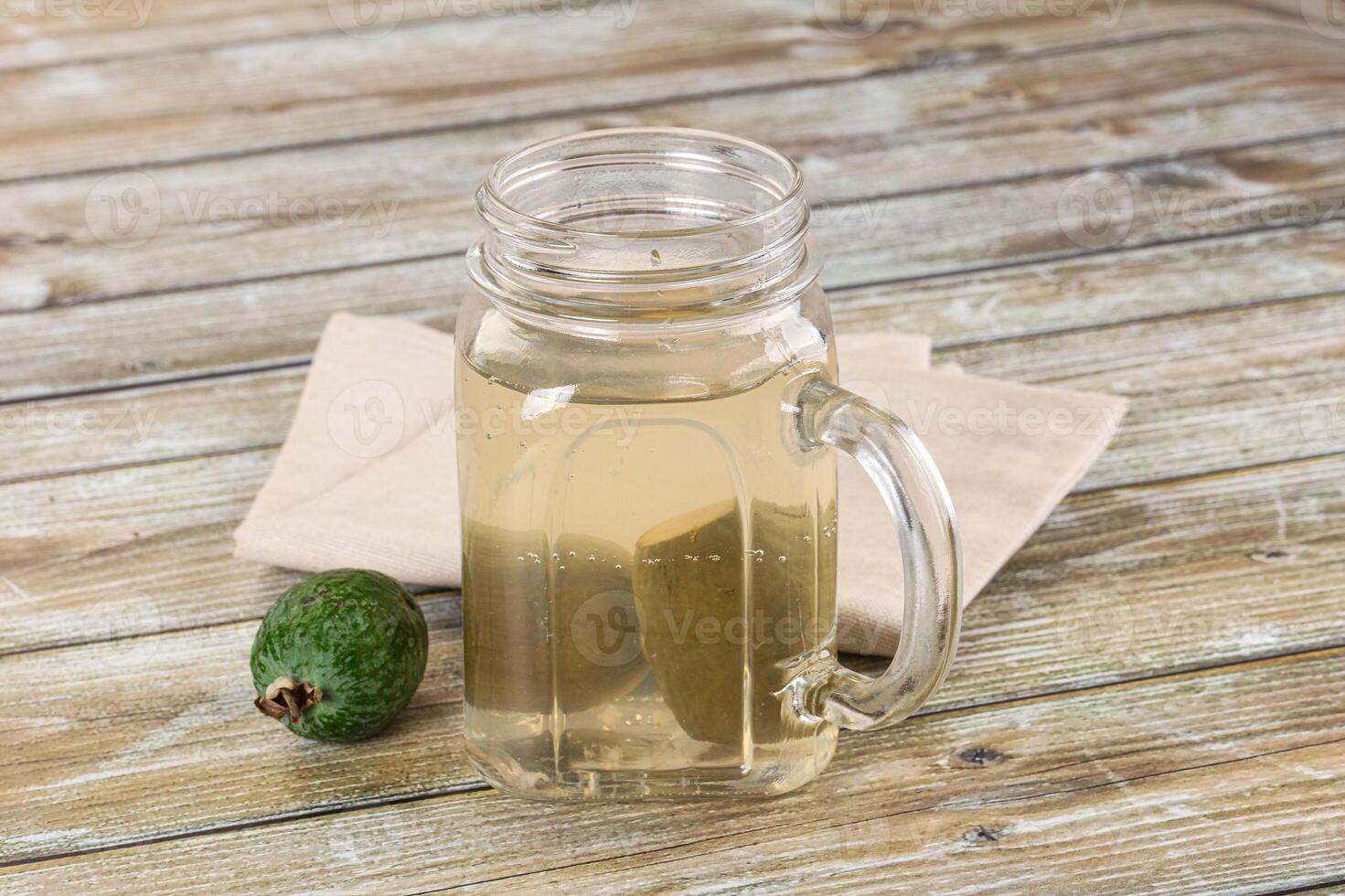 A glass jar with a green avocado and a napkin photo