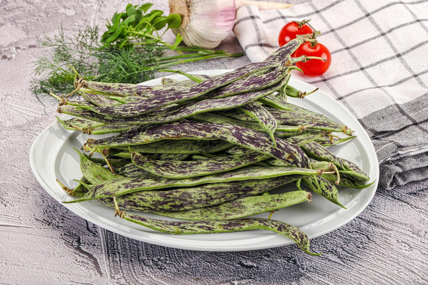 A plate of beans on a table with a knife and a knife photo