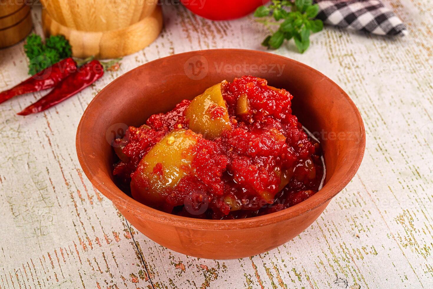 A bowl of red sauce with tomatoes and spices photo