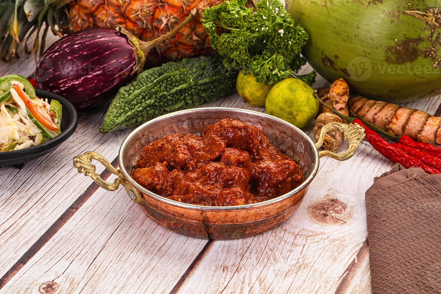 A wooden table with a bowl of food and other items photo