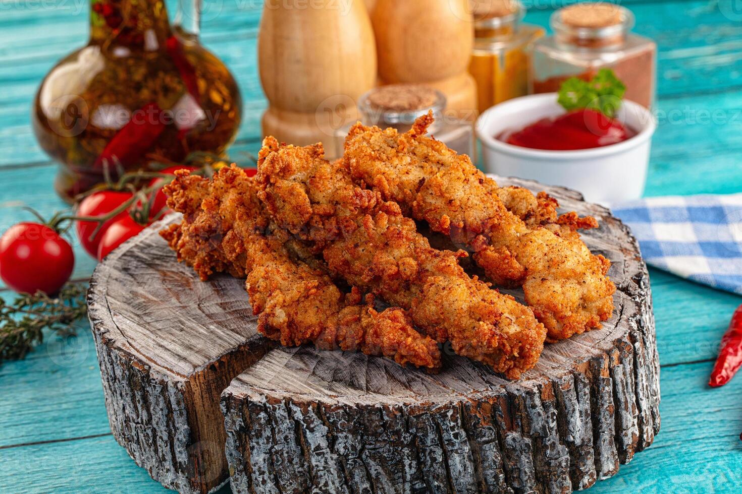 Fried chicken nuggets on a wooden stump photo
