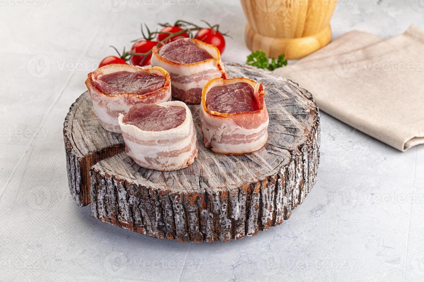 Bacon wrapped in bacon on a wooden log photo