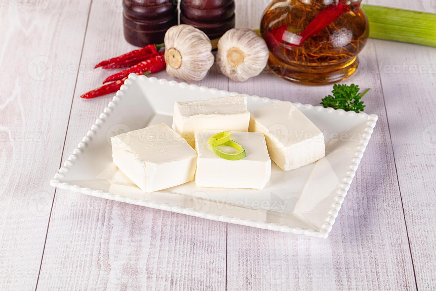 A white plate with cubes of tofu and garlic photo