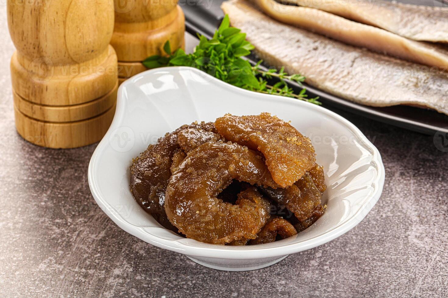 A bowl of food with some spices and a wooden spoon photo