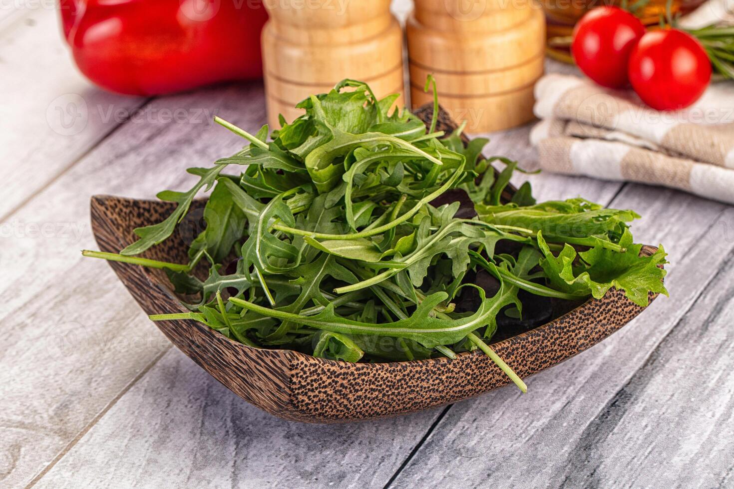 A wooden bowl filled with green salad photo