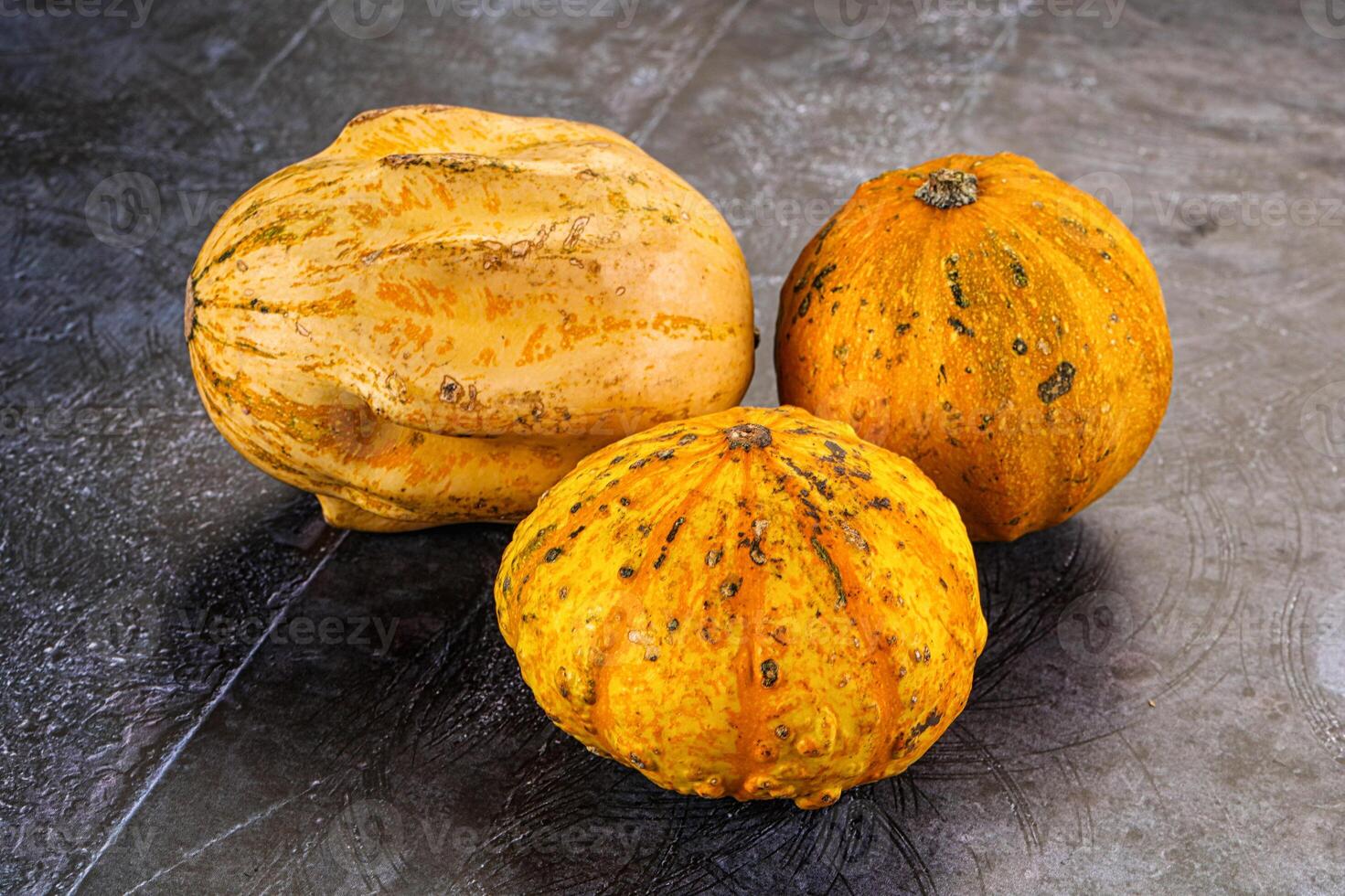 Three squash on a table with a black background photo