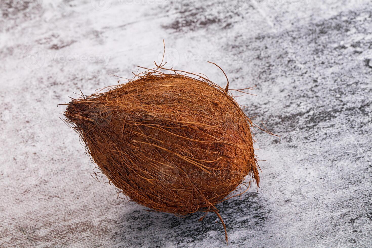 A coconut is sitting on a table photo