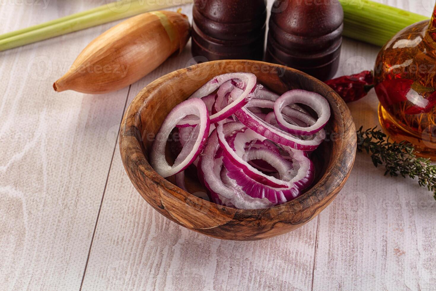 A wooden bowl filled with onions and other ingredients photo