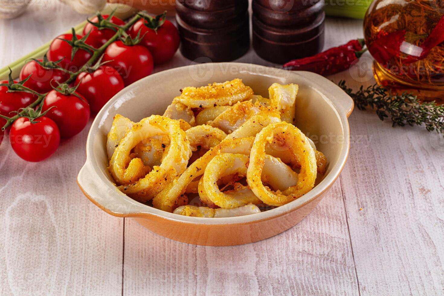 A bowl of food with onions and tomatoes on a table photo