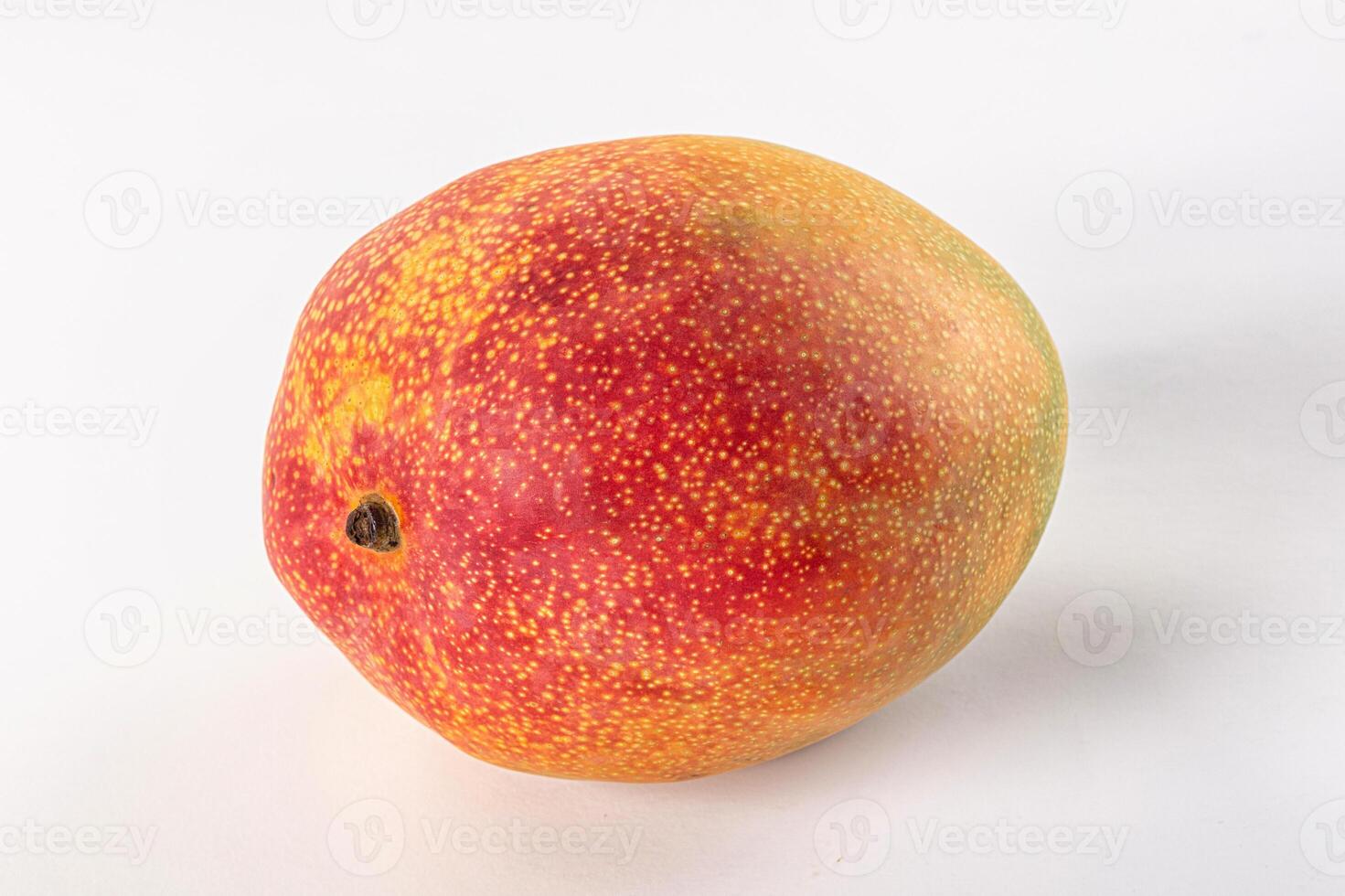A mango on a white surface photo
