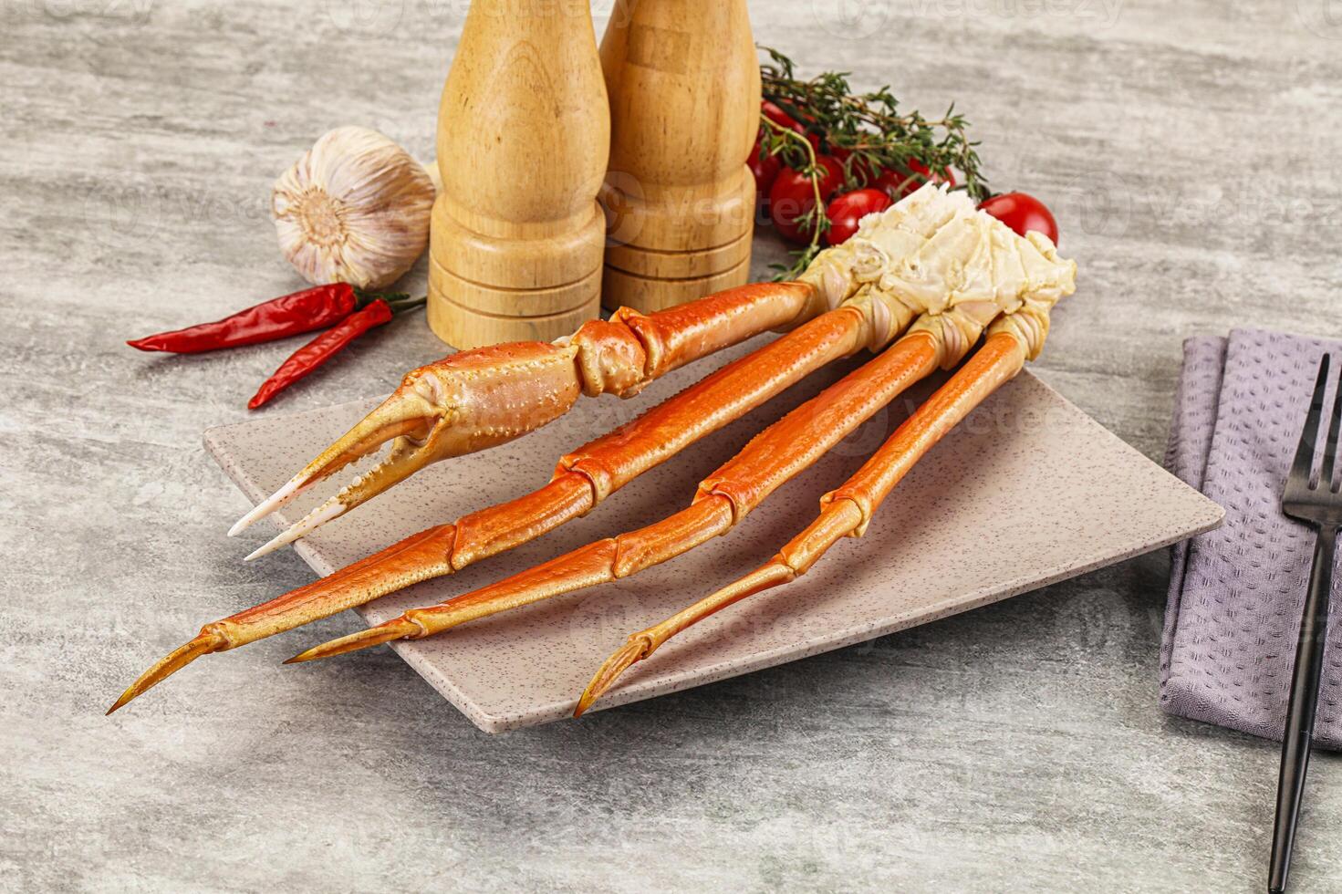 A plate with a crab leg and a bottle of wine photo